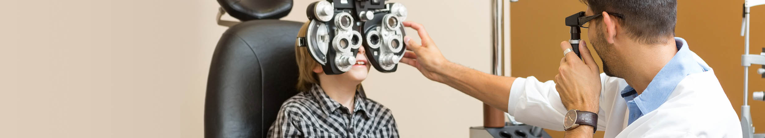 Small boy receiving eye exam in office